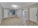 Spacious open-plan living room with tile floors, neutral paint, and natural light at 6110 N Suwanee Ave, Tampa, FL 33604