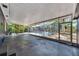Spacious covered patio with views of the screened pool and landscaped yard at 6110 N Suwanee Ave, Tampa, FL 33604