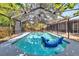 The screen enclosed pool, patio and pool furniture create a private and inviting outdoor oasis in the backyard at 6110 N Suwanee Ave, Tampa, FL 33604