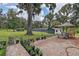 Spacious brick patio, potted plants and a view of a large, green backyard at 6234 Neff Lake Rd, Brooksville, FL 34601