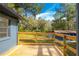 Wooden deck with a view of the outbuilding and a large grassy backyard at 6234 Neff Lake Rd, Brooksville, FL 34601