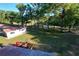 Large green backyard and view of the long outbuilding with a red roof at 6234 Neff Lake Rd, Brooksville, FL 34601