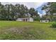 Charming one-story home with red tile roof, nestled among mature trees and lush green lawn at 6234 Neff Lake Rd, Brooksville, FL 34601