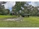 Expansive grassy yard with shed and storage area, surrounded by mature trees at 6234 Neff Lake Rd, Brooksville, FL 34601