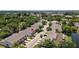 Scenic aerial view of townhouses near green spaces and pond in residential neighborhood at 6420 92Nd N Pl # 1205, Pinellas Park, FL 33782