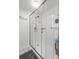 Updated bathroom featuring a tiled shower with glass doors and white walls at 6420 92Nd N Pl # 1205, Pinellas Park, FL 33782
