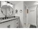 Modern bathroom with white vanity, round mirror, and walk-in shower at 6420 92Nd N Pl # 1205, Pinellas Park, FL 33782
