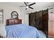 Bedroom with blue bedding, two dressers, barn door closet, and oval mirror at 6420 92Nd N Pl # 1205, Pinellas Park, FL 33782