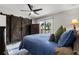 Bedroom with blue bedding, sliding glass door to balcony, and sliding barn door closet at 6420 92Nd N Pl # 1205, Pinellas Park, FL 33782