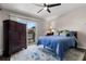 Bedroom with blue bedding, sliding glass door to balcony, and wood-look flooring at 6420 92Nd N Pl # 1205, Pinellas Park, FL 33782