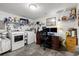 Functional utility room with washer, dryer, storage shelves, desk and monitors at 6420 92Nd N Pl # 1205, Pinellas Park, FL 33782