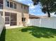 Backyard with an outdoor patio, chair, manicured lawn, and white fence; great for relaxing or entertaining at 6980 Ulmerton Rd # 7C, Largo, FL 33771