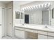 Well-lit bathroom with a double vanity, large mirror, and separate shower and bathtub areas at 6980 Ulmerton Rd # 7C, Largo, FL 33771