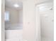 Bright bathroom featuring a tub and a walk-in shower with white tile surround at 6980 Ulmerton Rd # 7C, Largo, FL 33771