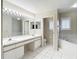 Bright bathroom featuring a dual sink vanity, tub, separate shower and toilet room, and tile floors at 6980 Ulmerton Rd # 7C, Largo, FL 33771