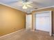 Bedroom featuring tan walls, carpet, a ceiling fan and an open closet at 6980 Ulmerton Rd # 7C, Largo, FL 33771
