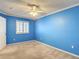 Bedroom with blue walls, carpet, ceiling fan, and window with shutters at 6980 Ulmerton Rd # 7C, Largo, FL 33771