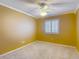 Bedroom featuring a window with shutters, neutral carpet, and yellow walls at 6980 Ulmerton Rd # 7C, Largo, FL 33771