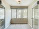 Bright bonus room with a large window, carpet flooring, neutral paint, and glass doors on either side at 6980 Ulmerton Rd # 7C, Largo, FL 33771