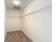 Walk-in closet features carpeted floors and metal shelving for storage at 6980 Ulmerton Rd # 7C, Largo, FL 33771