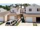 Charming townhomes showcase a well-maintained exterior, complemented by a palm tree and individual garages at 6980 Ulmerton Rd # 7C, Largo, FL 33771