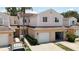 Exterior view of townhouse with attached garages, and well-maintained landscaping at 6980 Ulmerton Rd # 7C, Largo, FL 33771