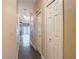Hallway view showcasing the doors, tile floors, and natural light from the living room french doors at 6980 Ulmerton Rd # 7C, Largo, FL 33771