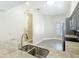Bright kitchen features granite counters, stainless appliances, and tile floors at 6980 Ulmerton Rd # 7C, Largo, FL 33771
