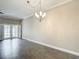 Spacious living room featuring a modern chandelier, tiled floors and doors to the patio at 6980 Ulmerton Rd # 7C, Largo, FL 33771