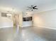 Inviting living room with modern ceiling fan, tiled floors, and an open view to the kitchen at 6980 Ulmerton Rd # 7C, Largo, FL 33771