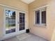 Cozy screened patio with outdoor access through French doors and a bright window at 6980 Ulmerton Rd # 7C, Largo, FL 33771