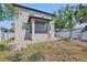 This property includes a backyard, porch with screen, brick patio and a white fence at 7307 S Morton St, Tampa, FL 33616