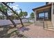 Large backyard features a brick patio, steps leading to the screened in porch, and a white fence at 7307 S Morton St, Tampa, FL 33616