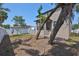 This property features a large backyard with a screen porch, mature trees and white fence at 7307 S Morton St, Tampa, FL 33616