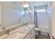 Bright bathroom featuring a double vanity, granite countertop, tub and modern fixtures at 7307 S Morton St, Tampa, FL 33616
