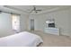 Bright bedroom featuring neutral walls, carpet, tray ceiling and access to ensuite bathroom at 7307 S Morton St, Tampa, FL 33616
