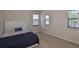 Cozy bedroom with carpeted floors, neutral walls, and bright natural light from the windows at 7307 S Morton St, Tampa, FL 33616