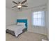 Cozy bedroom featuring a ceiling fan, a large window and a comfortable single bed at 7307 S Morton St, Tampa, FL 33616
