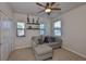 Cozy bedroom with a comfortable gray sofa, ceiling fan, and good natural light at 7307 S Morton St, Tampa, FL 33616