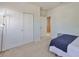 Bright bedroom features neutral carpet, double closet, and a doorway leading to another room at 7307 S Morton St, Tampa, FL 33616