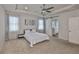 Spacious bedroom featuring a tray ceiling, ceiling fan, ensuite access and ample natural light at 7307 S Morton St, Tampa, FL 33616