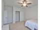 Clean bedroom with carpet floors, ceiling fan, closet, and a bright neutral color scheme at 7307 S Morton St, Tampa, FL 33616