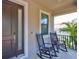 Cozy front porch with rocking chairs, perfect for relaxing and enjoying the neighborhood views at 7307 S Morton St, Tampa, FL 33616
