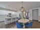 Bright, modern kitchen flowing into dining area, featuring stainless appliances and granite counters at 7307 S Morton St, Tampa, FL 33616