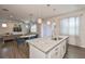 Open kitchen with island, modern lighting, stainless appliances and adjacent dining area at 7307 S Morton St, Tampa, FL 33616