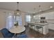 Open-concept kitchen featuring a large island, pendant lighting, and modern appliances at 7307 S Morton St, Tampa, FL 33616