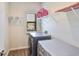 Functional laundry room with washer, dryer, shelving, and a bright window at 7307 S Morton St, Tampa, FL 33616