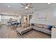 Open-concept living space with kitchen, dining area, and living room featuring wood-look floors at 7307 S Morton St, Tampa, FL 33616