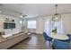 Well-lit living room showcases comfortable seating and dining area with modern decor at 7307 S Morton St, Tampa, FL 33616