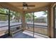 Relaxing screened patio featuring a ceiling fan, decorative lights, and a view of the backyard at 7307 S Morton St, Tampa, FL 33616
